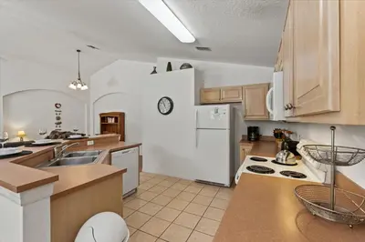 a kitchen with a white refrigerator and a sink at CLD4676 in Kissimmee
