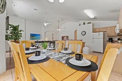 a kitchen and dining room with a table and chairs at CLD4676 in Kissimmee