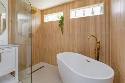 a bathroom with a tub and a glass shower at Hope House- Vacation Village 1 Bedroom with Loft in Clermont