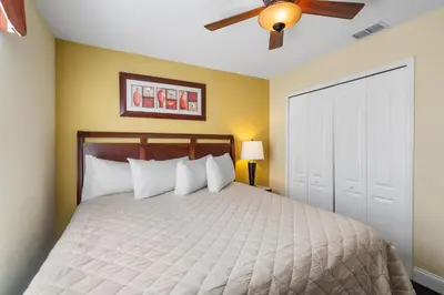 a bedroom with a bed with a ceiling fan at CUP8931 in Kissimmee