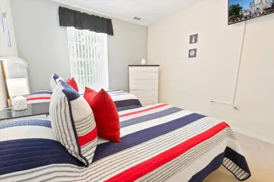 a bedroom with two beds with red and blue pillows at CCL8536 in Kissimmee