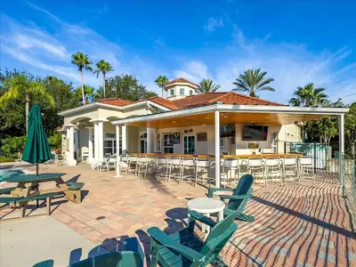 a house with chairs and tables and a patio at CCL8536 in Kissimmee