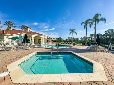 a swimming pool with palm trees and a house at CCL8536 in Kissimmee
