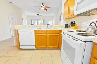 a kitchen with white appliances and a stove top oven at CCL8536 in Kissimmee
