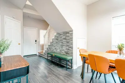 a dining room with a table and chairs at Full House HotTub Mins to UCF in Bithlo