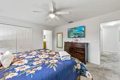 a bedroom with a bed and a ceiling fan at Wonderful 4 bed Family Home with Private Pool in Kissimmee