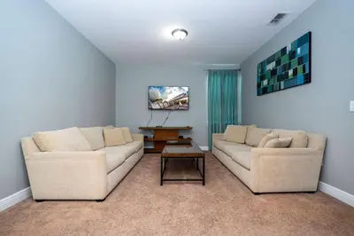 a living room with two couches and a coffee table at Classic 8bd house - Encore Reunion Close to Disney in Orlando