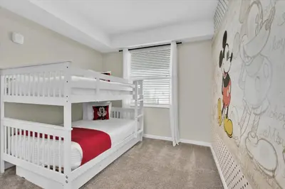 a childs bedroom with white bunk beds and a window at PXC3151-306 in Kissimmee