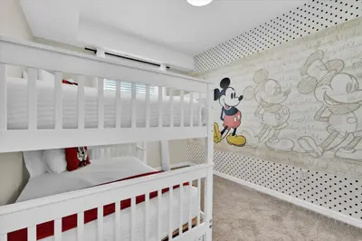 a childs room with white bunk beds with mickey mouse wallpaper at PXC3151-306 in Kissimmee