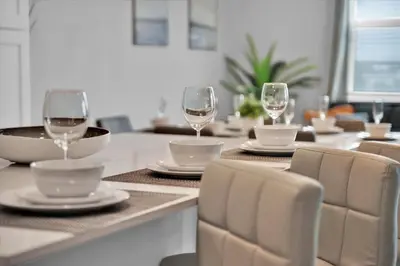 a dining room table with wine glasses on it at PXC3151-306 in Kissimmee