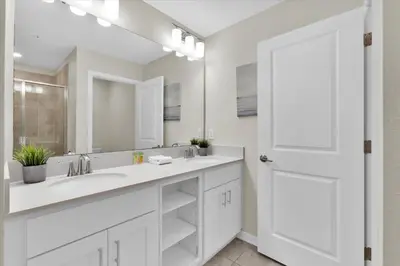 a white bathroom with a sink and a mirror at PXC3151-306 in Kissimmee