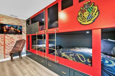 a red bunk bed room with two beds and a chair at SHD4724 in Kissimmee