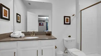 a white bathroom with a sink and a toilet at OMW2718 in Kissimmee