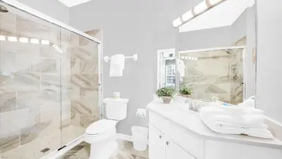 a bathroom with a shower and a toilet and a sink at ALM2788-301 in Orlando