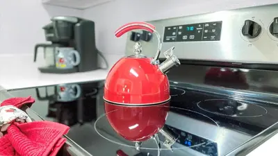 a red mixer sitting on top of an oven at ALM2788-301 in Orlando