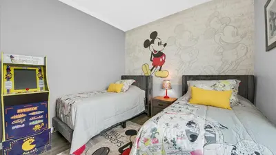 a bedroom with two beds and a mickey mouse mural at ALM2788-301 in Orlando