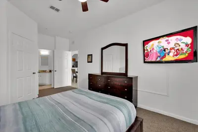 a bedroom with a bed and a tv on the wall at ALM2785-304 in Orlando