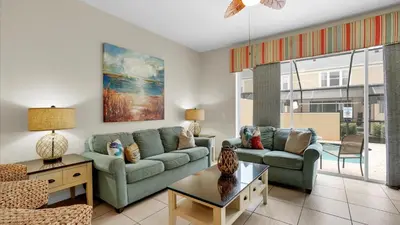 a living room with a couch and a table at SKC7653 in Orlando