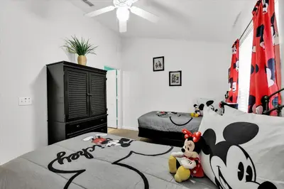 a bedroom with a bed with a mickey mouse headboard at SKC7644 in Orlando