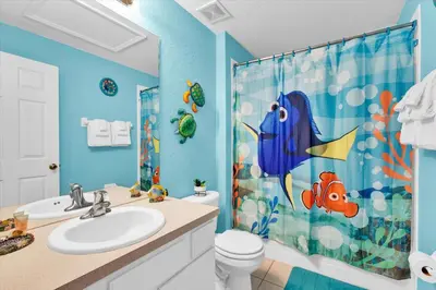 a blue bathroom with a toilet and a shower curtain at SKC7644 in Orlando