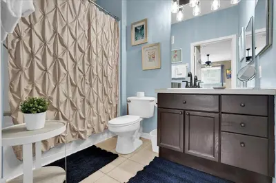 a bathroom with a toilet and a shower curtain at SPD2302-103 in Kissimmee