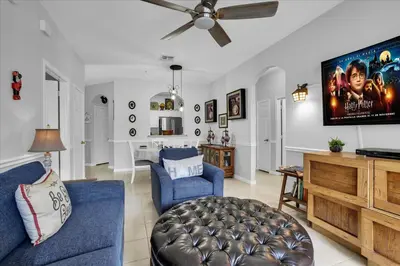 a living room with a blue couch and a tv at SPD2302-103 in Kissimmee