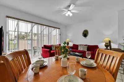 a dining room with a table and chairs and a couch at SPD2319 in Kissimmee