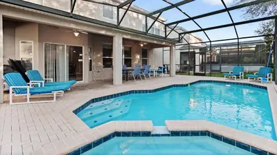 a swimming pool with blue chairs and a house at DB2644 Windsor Hills Resort 6 Bedroom in Orlando