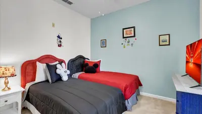 a bedroom with two beds with red sheets at BF2302-203 Windsor Palms Resort 3 Bedroom in Kissimmee