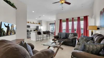 a living room with two couches and a table at KP8034 Windsor Palms Resort 4 Bedroom Private Pool in Kissimmee