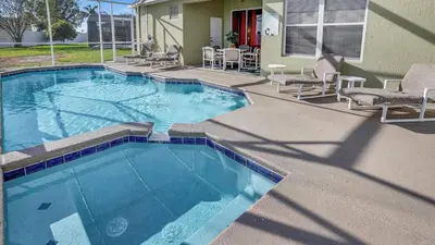 a swimming pool with chairs and a house at KP8034 Windsor Palms Resort 4 Bedroom Private Pool in Kissimmee