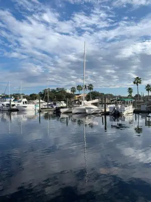 a group of boats docked in a marina with a cloudy sky at The Famous Houseboat in Sanford in Sanford