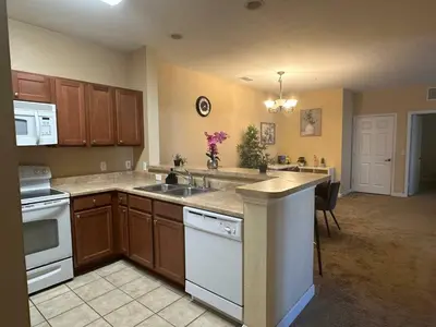 a kitchen with a sink and a stove top oven at Cozy condo Just a few minutes from Disney in Kissimmee