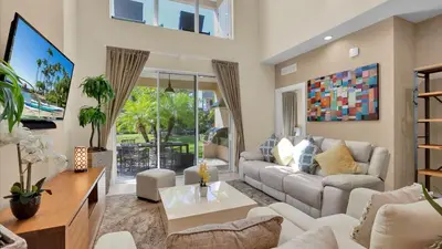 a living room with a couch and a tv at RCF7646 in Orlando