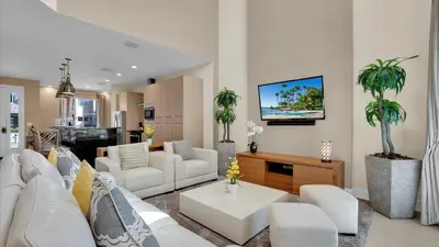 a living room with white furniture and palm trees at RCF7646 in Orlando