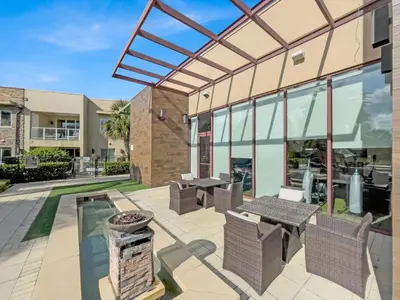a patio with tables and chairs in front of a building at RCF7646 in Orlando