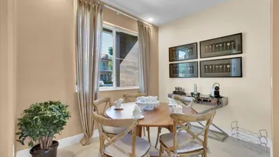 a dining room with a table and chairs and a window at RCF7646 in Orlando