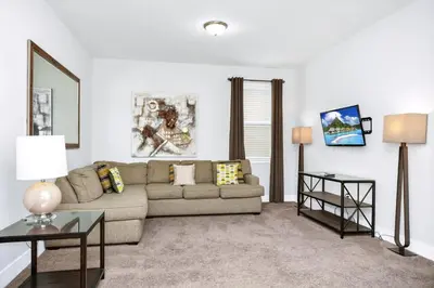 a living room with a couch and a table at Charming Home With Private Pool, Theme Rooms And Foosball Table Near Disney With Waterpark & Resort Access At Encore - 370La in Kissimmee