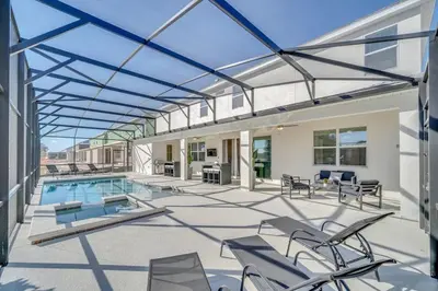 an indoor patio with a swimming pool and chairs at 2525 Shanti Amazing 15 Suites Mansion in Kissimmee