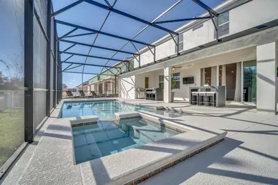 a swimming pool in a house with a glass ceiling at 2525 Shanti Amazing 15 Suites Mansion in Kissimmee