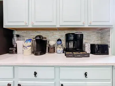 a kitchen counter with a coffee maker on it at Group retreat w pool, spa & BBQ in Orlando