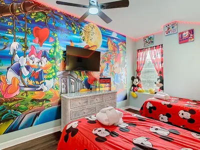 a childs bedroom with a mickey mouse mural at Group retreat w pool, spa & BBQ in Orlando