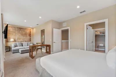 a bedroom with a bed and a living room at Minutes to Disney Chic Dream Villa with Stunning Patio and Resort Perks in Orlando