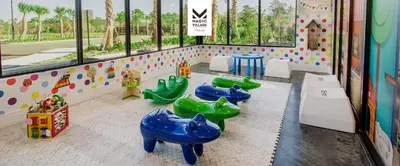 a childrens indoor play area with blue and green slides at Minutes to Disney Chic Dream Villa with Stunning Patio and Resort Perks in Orlando