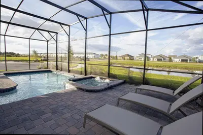 a glass igloo with a pool and chairs in it at Epic Dream Home with Spa Game Room Themed Bedrooms 2887 Single Family in Kissimmee