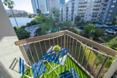 a balcony with chairs and a view of the water at Luxury Lakeview Getaway 1 mile Universal Studios in Orlando