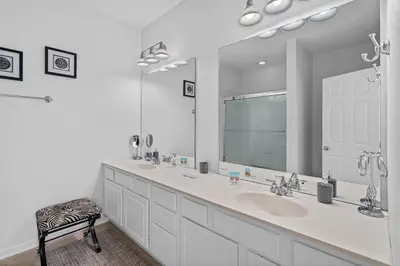 a bathroom with two sinks and a large mirror at Comfortable 3BR Near Convention Center & Epic Park in Orlando
