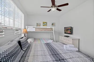 a bedroom with a bed with a ceiling fan at Comfortable 3BR Near Convention Center & Epic Park in Orlando