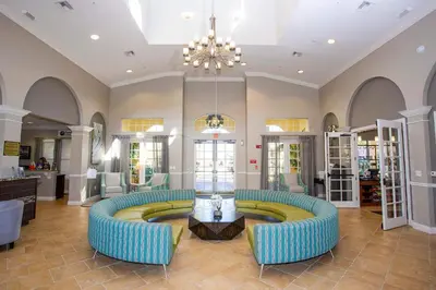a lobby with two blue couches and a table at Comfortable 3BR Near Convention Center & Epic Park in Orlando