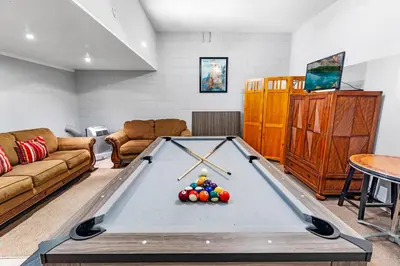 a living room with a pool table at Disney Doorstep 7 Bedroom Villa with SouthFacing Pool and Hot Tub in Kissimmee